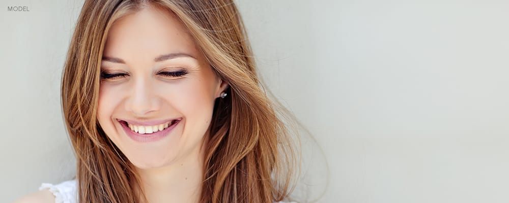 Headshot of Young Woman Smiling with her Eyes Closed