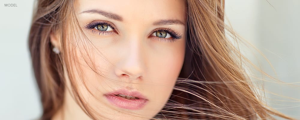 Headshot of Young Brunette Woman with Somber Stare