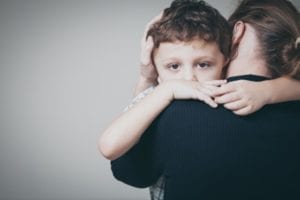 Back of a Woman Holding Her Son