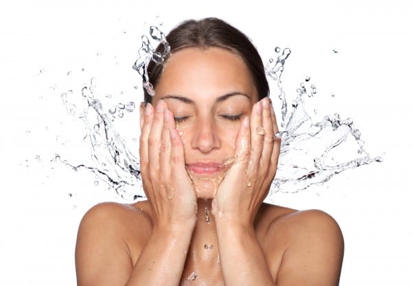 Woman Splashing Water on Her Face