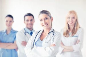 Female Doctor with Staff Behind Her