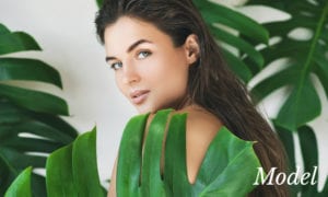 Model Behind Large Green Leaves