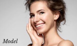 Smiling Model with Sharp Nose Touching Face with Hand
