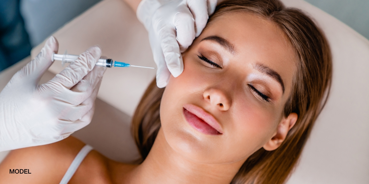 Female patient getting filler injected in her face